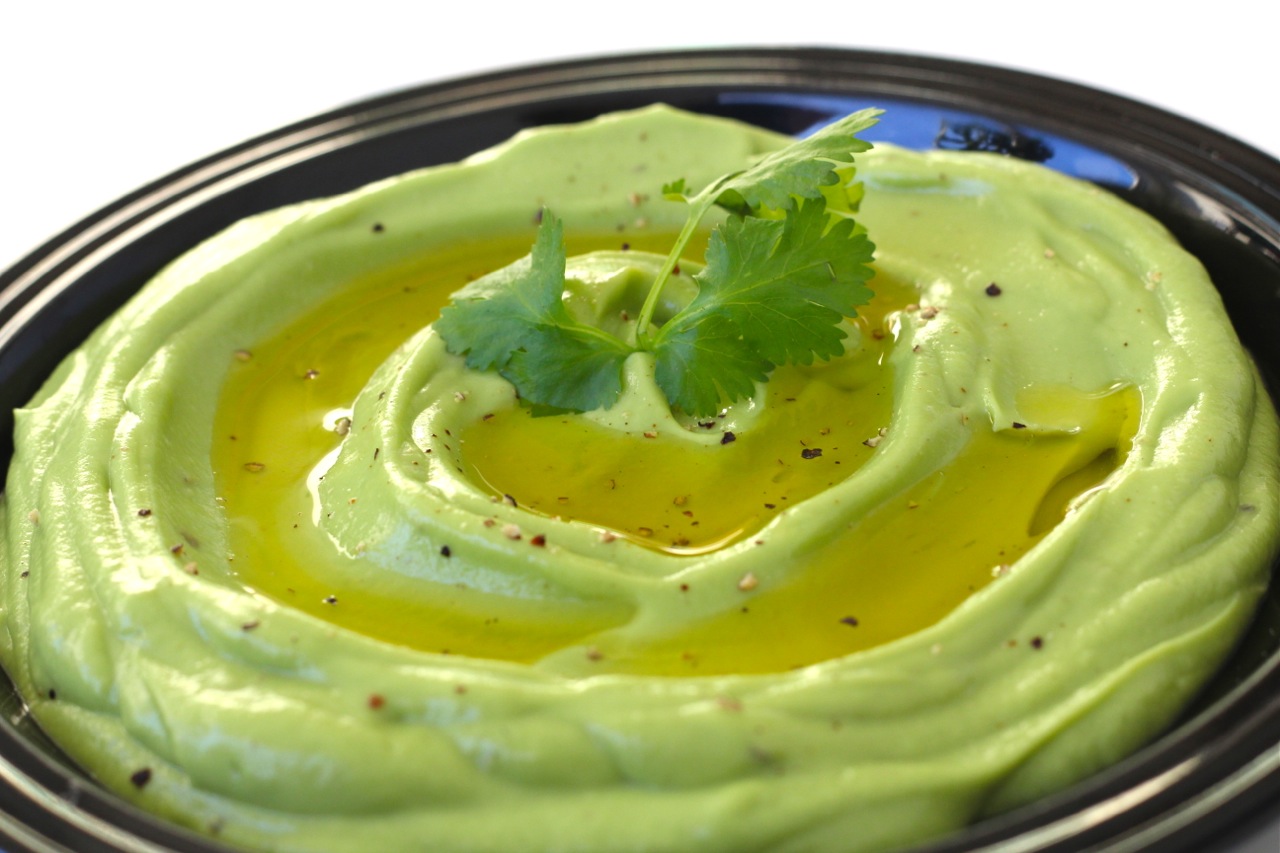 creamy avocado dip with a swirl of olive oil on top