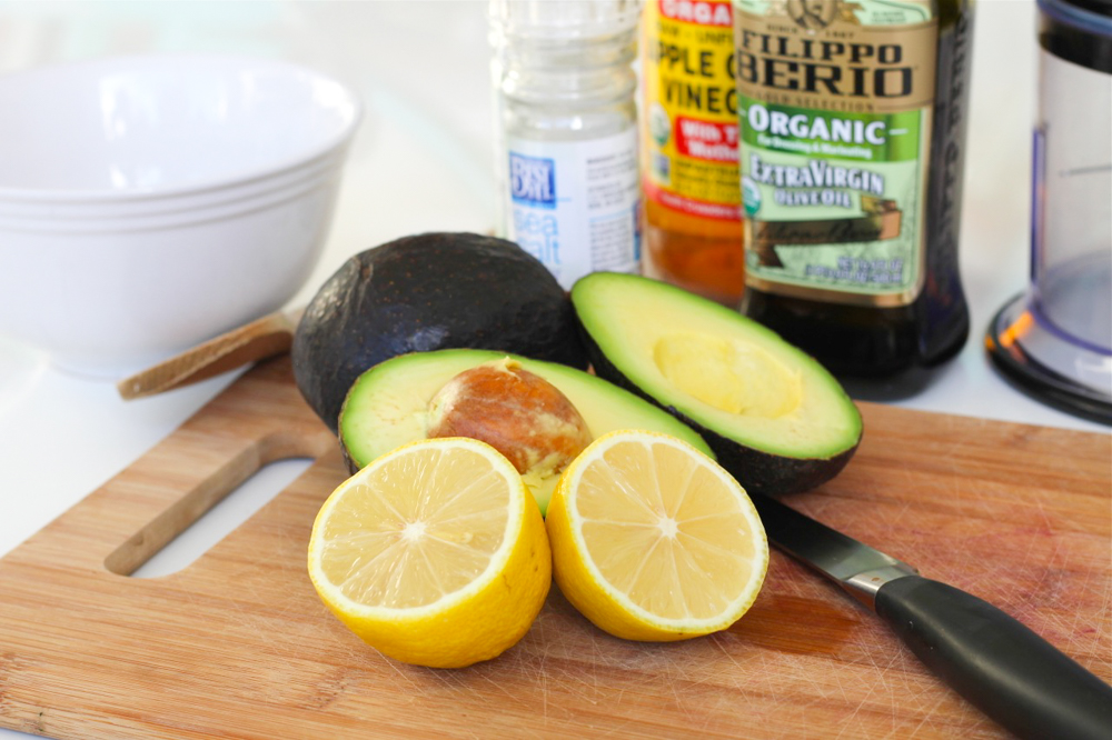 cutting board with avocados and lemons