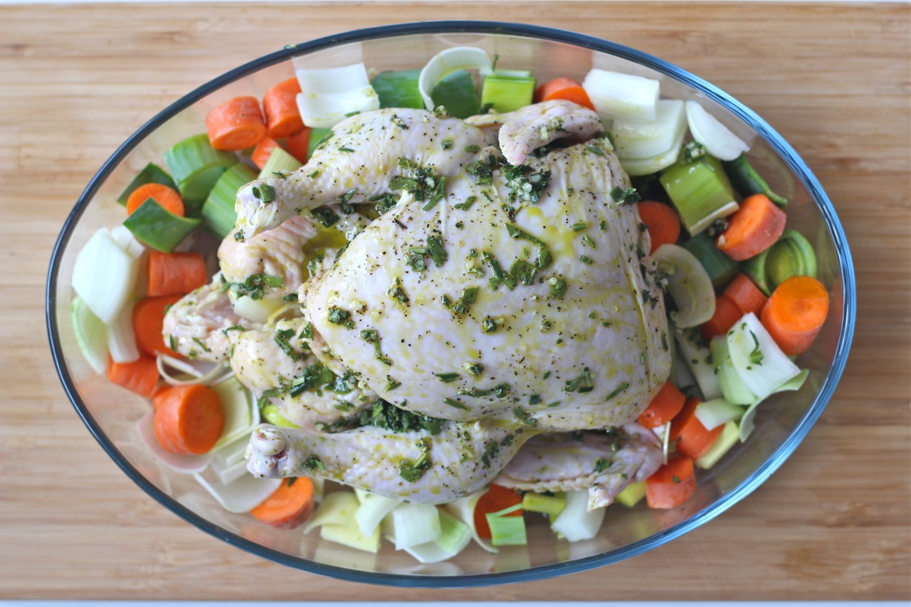 marinated whole chicken with vegetables in a casserole