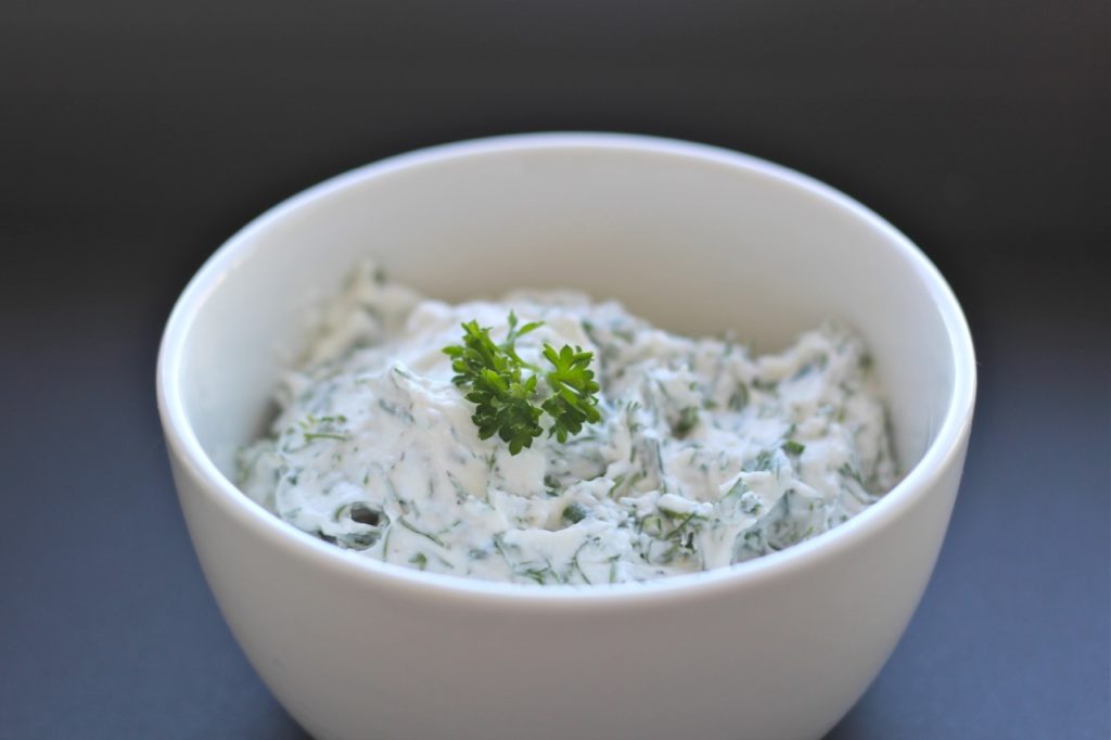 white bowl with yogurt herb dip