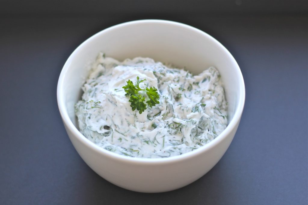 white bowl with yogurt herb dip