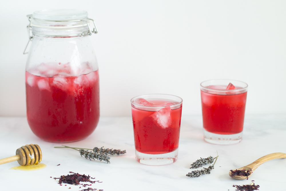 glasses and pitcher with ice cold hibiscus lavender iced tea