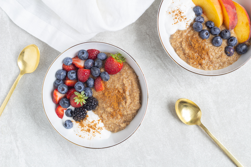 two bowls with oatmeal berries and peaches