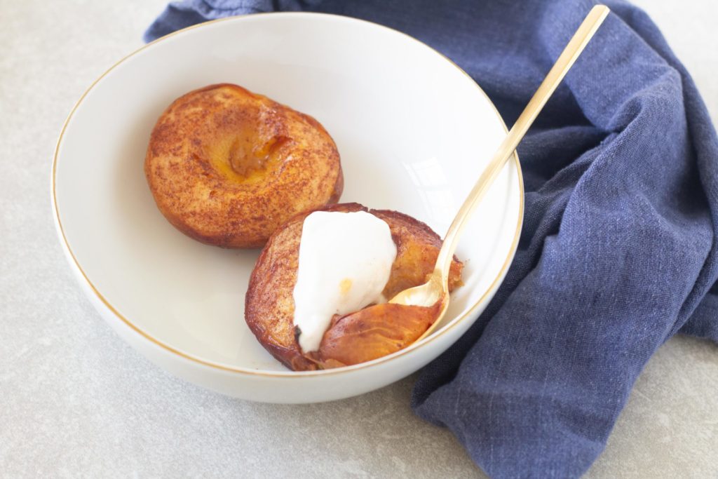 bowl of baked peaches with coconut yogurt