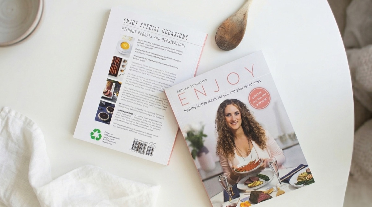 Enjoy — a festive AIP and Paleo cookbook by Annika Schimmer, showing the front and back cover